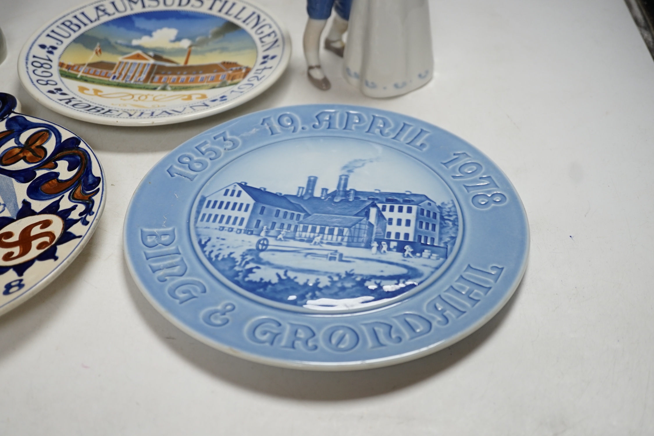 Three Royal Copenhagen and Bing and Grondahl commemorative plates and two figure groups, largest Carlsberg commemorative advertising plate 25.5cm high